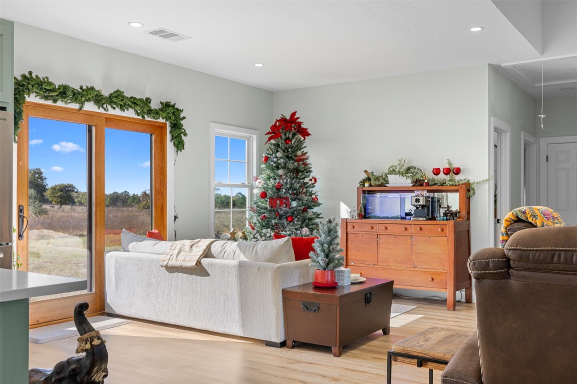 Living area featuring attic access, light wood-type flooring, and recessed lighting