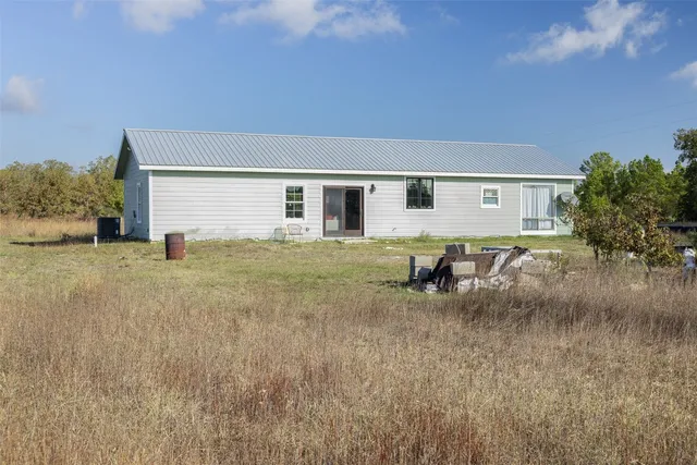 a backyard of a house with yard and outdoor seating