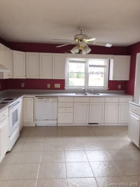 154 Brightmore Circle Rutherfordton, NC 28139 - Photo 2 of 7 a kitchen with a white cabinets and window