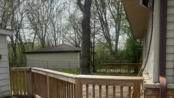 a view of a wooden deck next to a yard