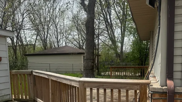 a view of a wooden deck next to a yard