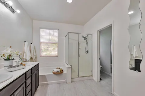 a bathroom with a sink double vanity and shower