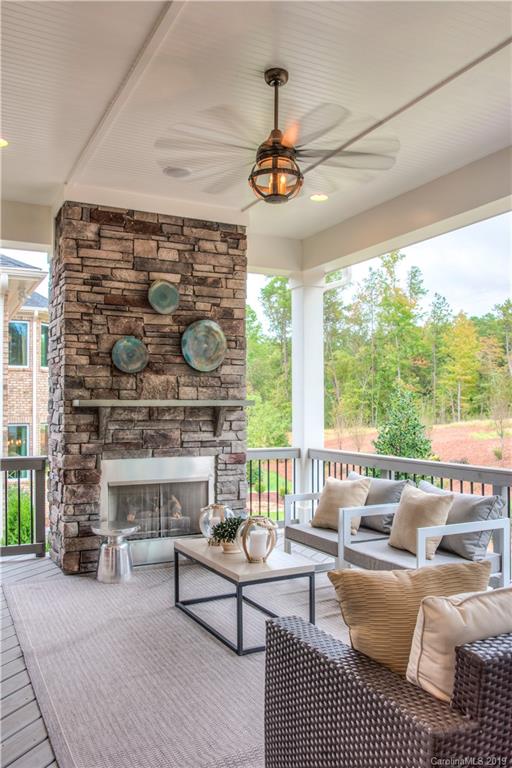 3047 Fish Story Court, Unit 371 Fort Mill, SC 29708 - Photo 1 of 1 a living room with furniture a fireplace and a floor to ceiling window