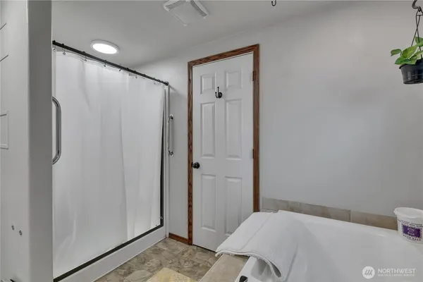 a bedroom with a bed and a bathroom
