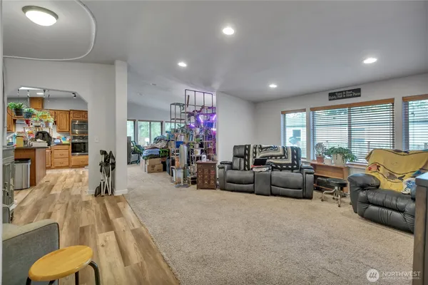 a living room with furniture a couch and a large window