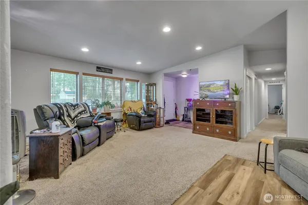 a living room with furniture a fireplace and a large window