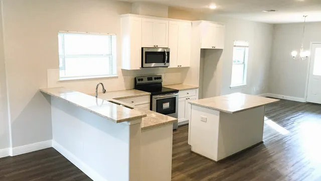 a kitchen with a sink stove and refrigerator