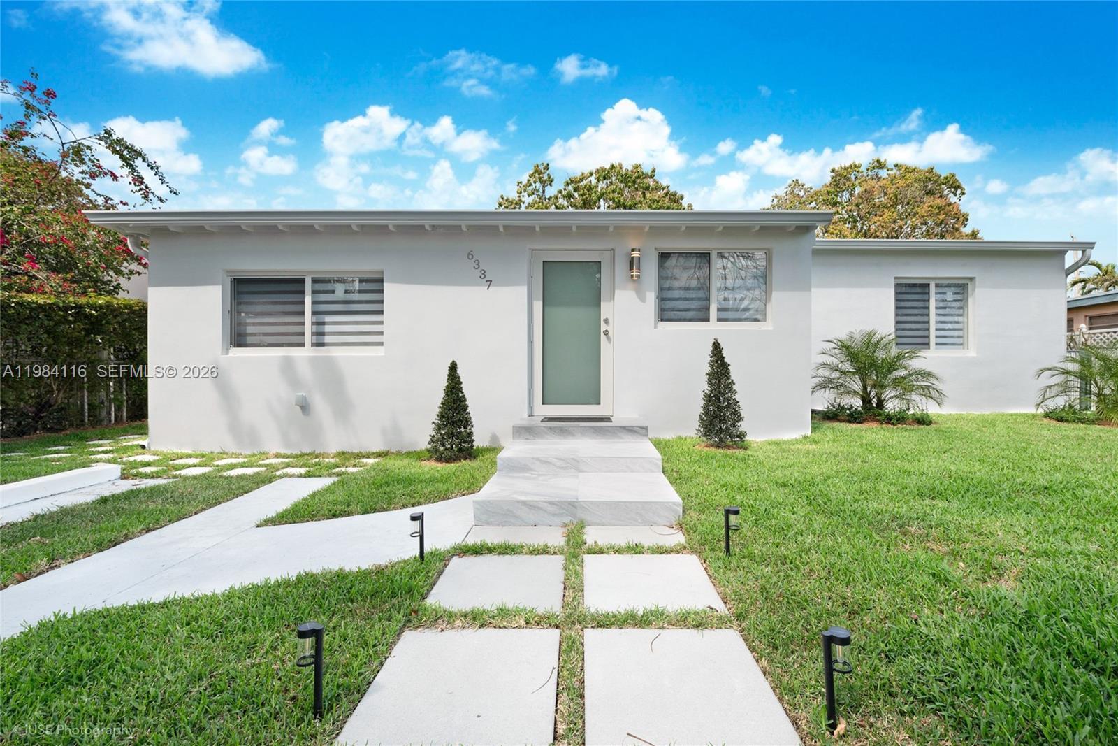 6337 Southwest 11th Street West Miami, FL 33144 - Photo 2 of 28 a front view of a house with garden