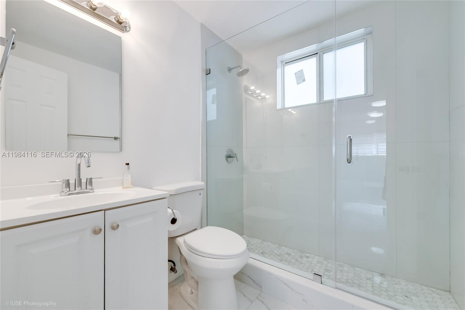 6337 Southwest 11th Street West Miami, FL 33144 - Photo 22 of 28 a bathroom with a sink a toilet and shower