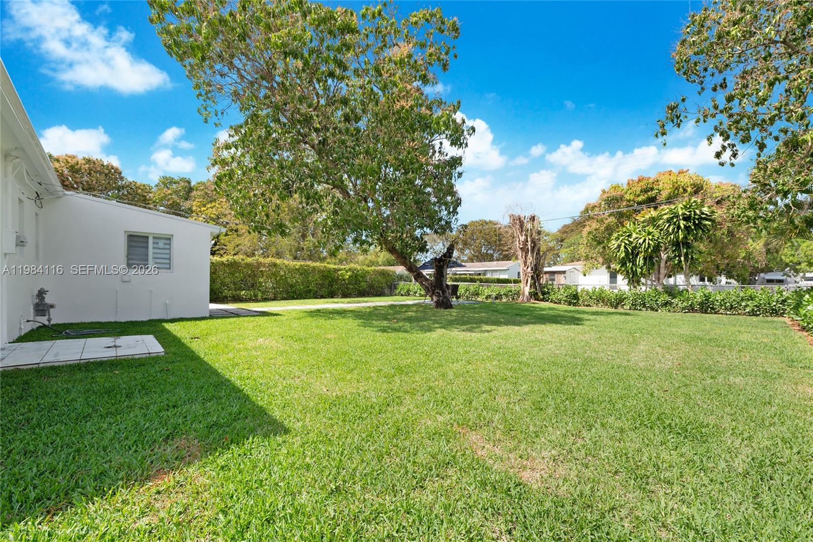 6337 Southwest 11th Street West Miami, FL 33144 - Photo 27 of 28 a view of backyard of house with green space