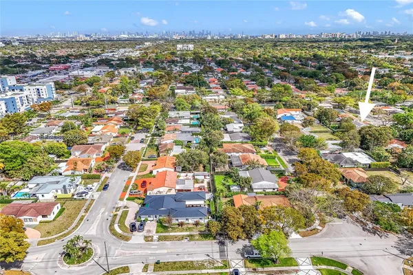 an aerial view of residential building with green space