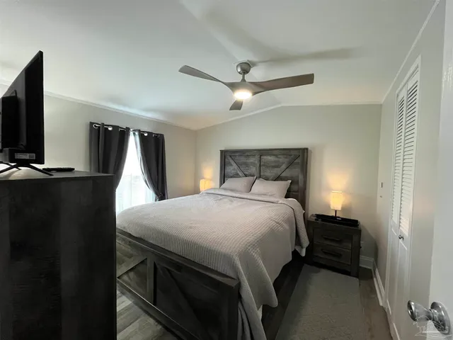 a bedroom with a bed and a flat screen tv