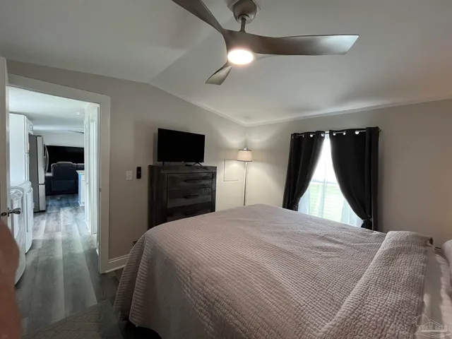 a room with a bed and a television