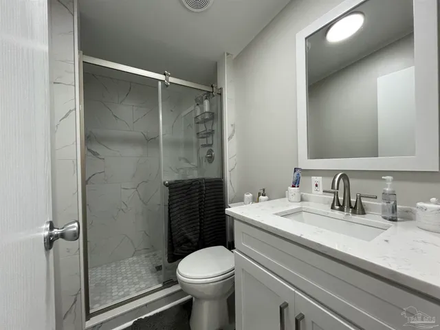a bathroom with a sink toilet and shower