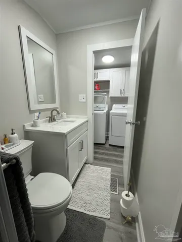 a bathroom with a sink toilet and mirror