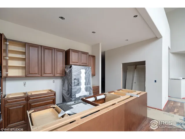 a kitchen with a refrigerator and a stove top oven