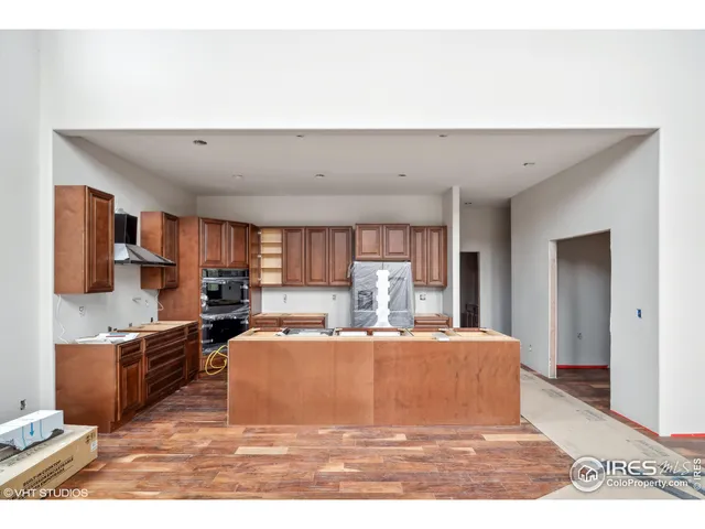 a living room with stainless steel appliances kitchen island sink refrigerator and stove