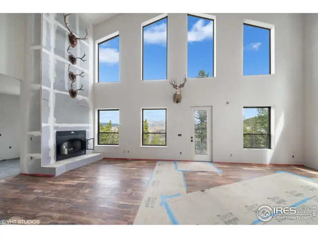 a view of a livingroom with a fireplace and window