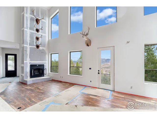 a view of a livingroom with a fireplace and window