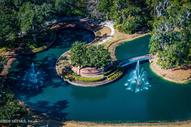 an aerial view of a swimming pool patio chairs and fire pit