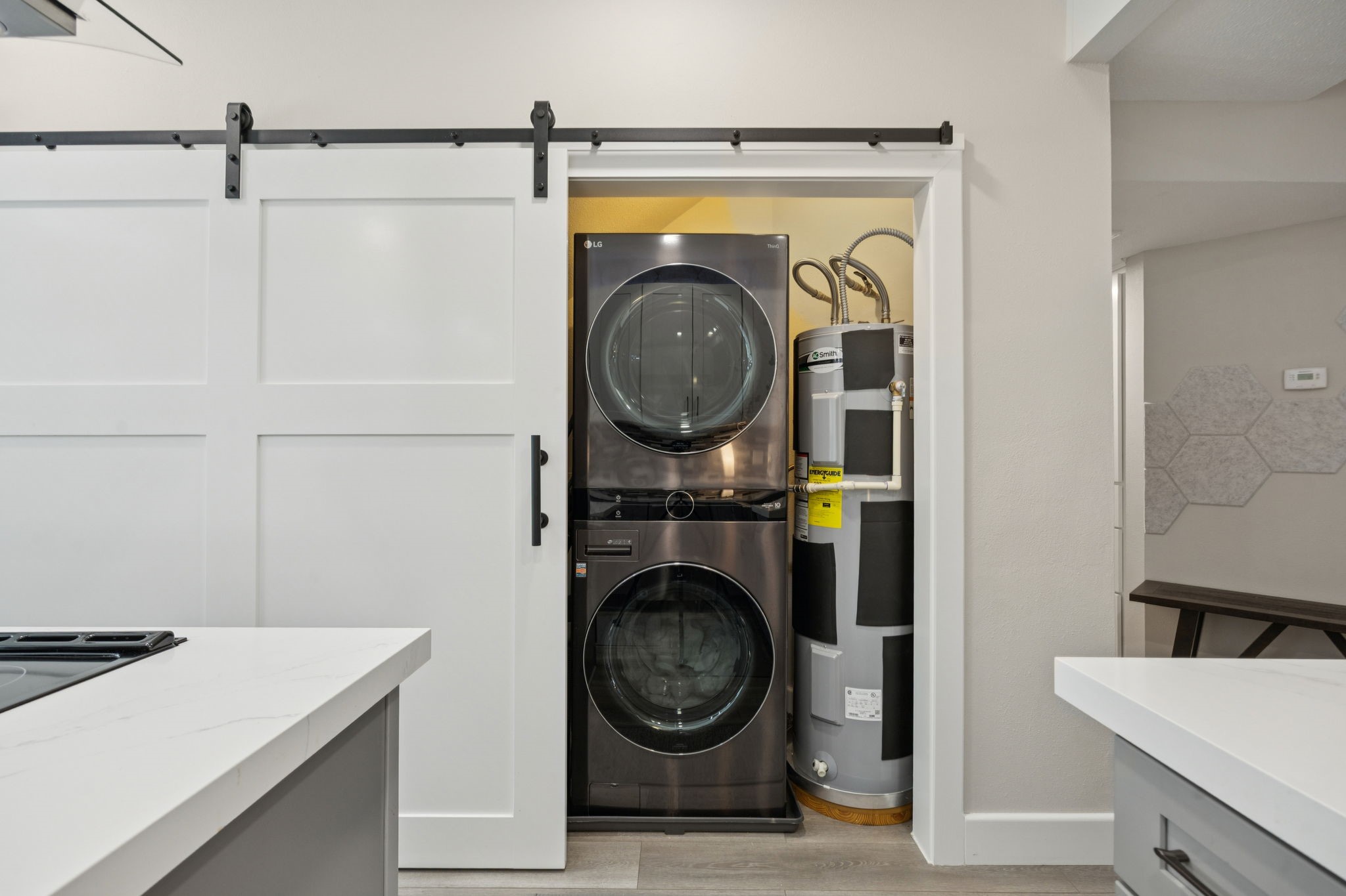 500 River Road, Unit 106 Montgomery, TX 77356 - Photo 14 of 32 Behind the sliding door, find a full size utility room, stackable washer and dryer, and hot water heater.