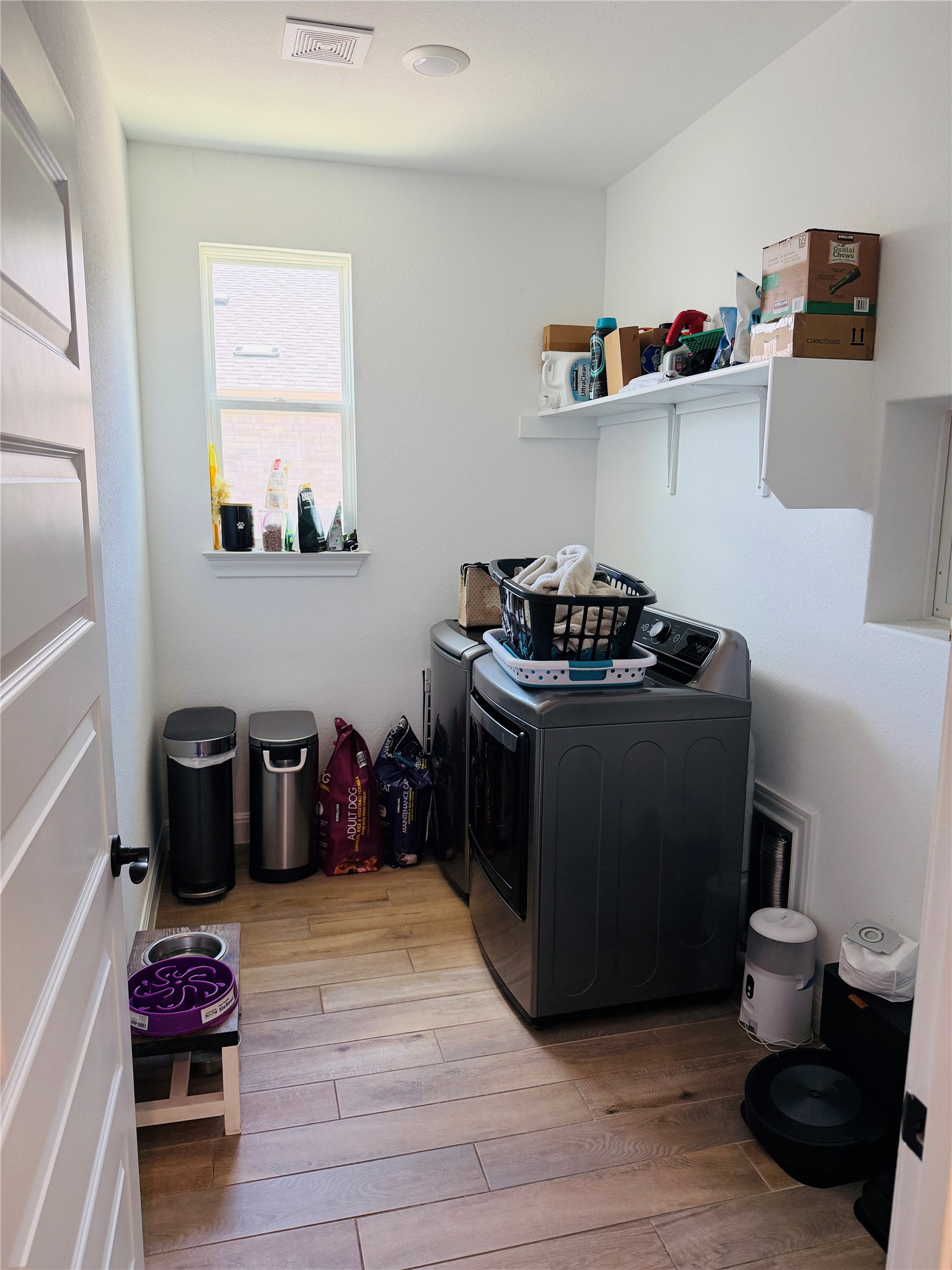 268 Fish Trap Road Dripping Springs, TX 78620 - Photo 20 of 23 A window brings natural light into this functional laundry space with wood-look flooring.
