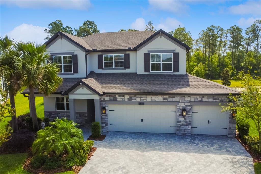 a front view of a house with a garden