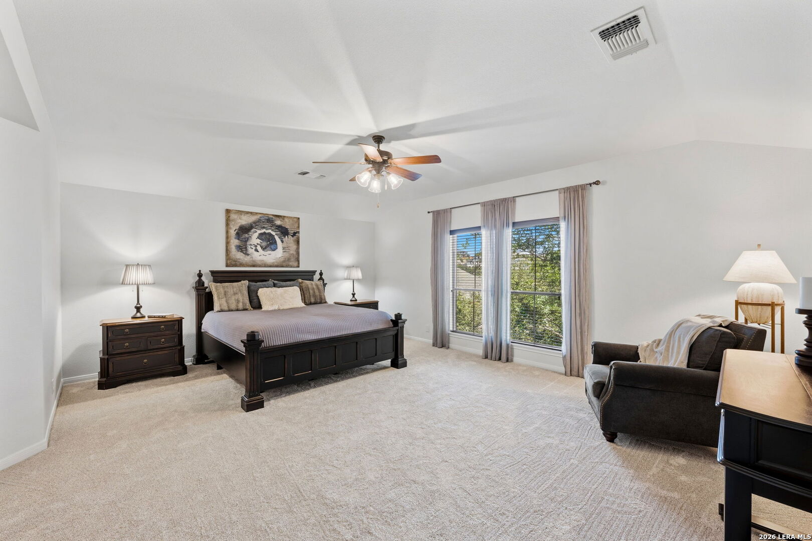14507 John David Helotes, TX 78023 - Photo 13 of 52 a bedroom with a bed a couch and a chandelier