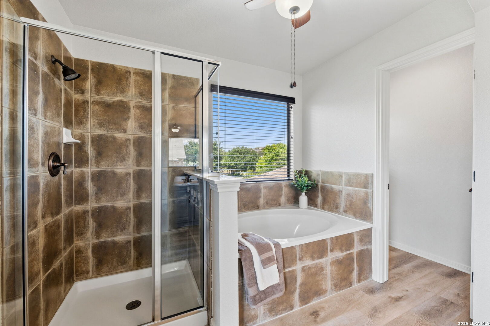 14507 John David Helotes, TX 78023 - Photo 15 of 52 a bathroom with a tub shower and window