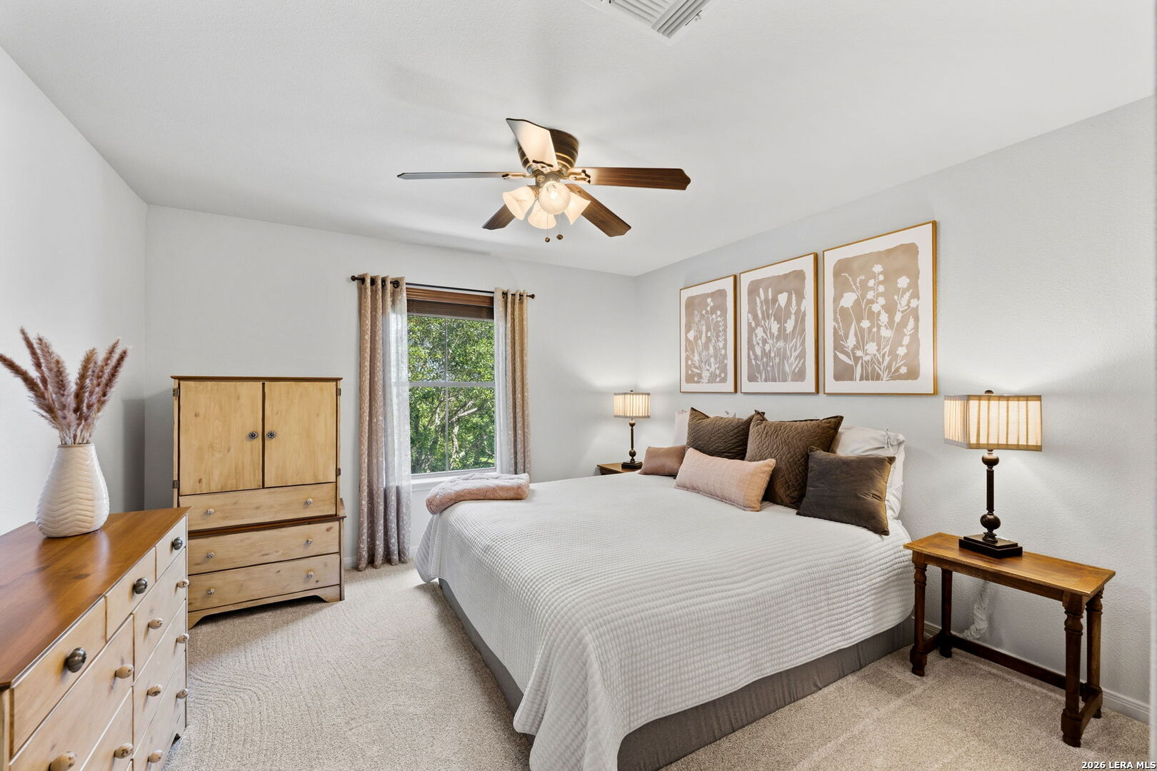 14507 John David Helotes, TX 78023 - Photo 19 of 52 a bedroom with a bed and a chandelier