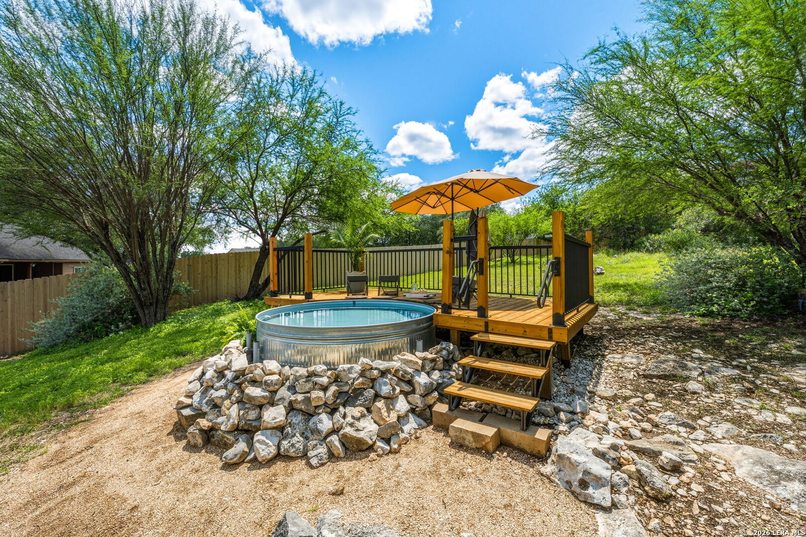 14507 John David Helotes, TX 78023 - Photo 25 of 52 a view of a backyard with a garden and entertaining space