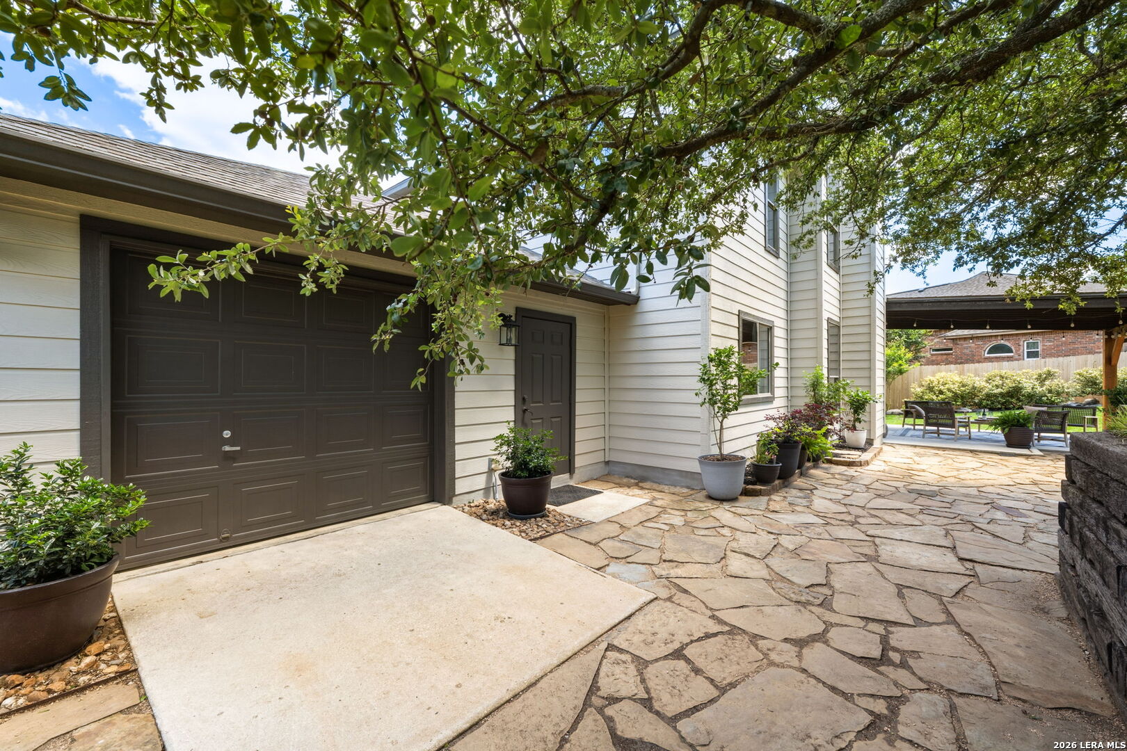 14507 John David Helotes, TX 78023 - Photo 26 of 52 a view of a backyard with a large tree