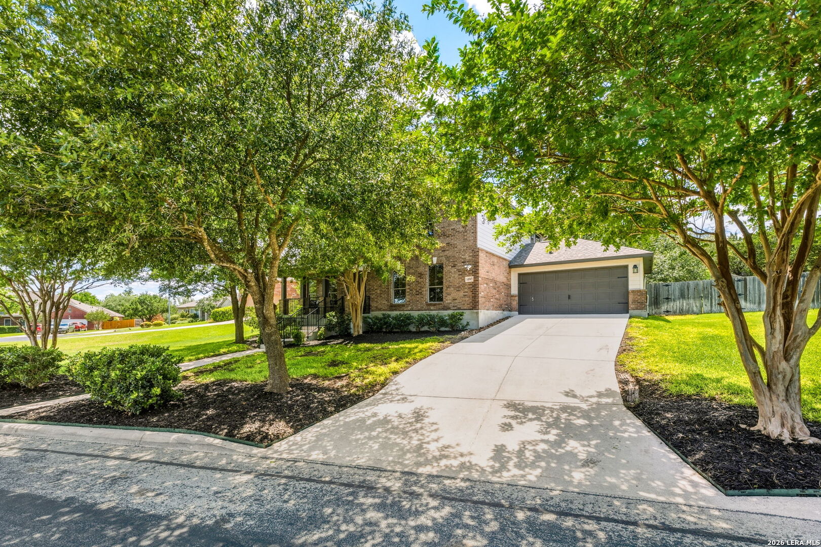 14507 John David Helotes, TX 78023 - Photo 37 of 52 a front view of a house with a yard and a garden