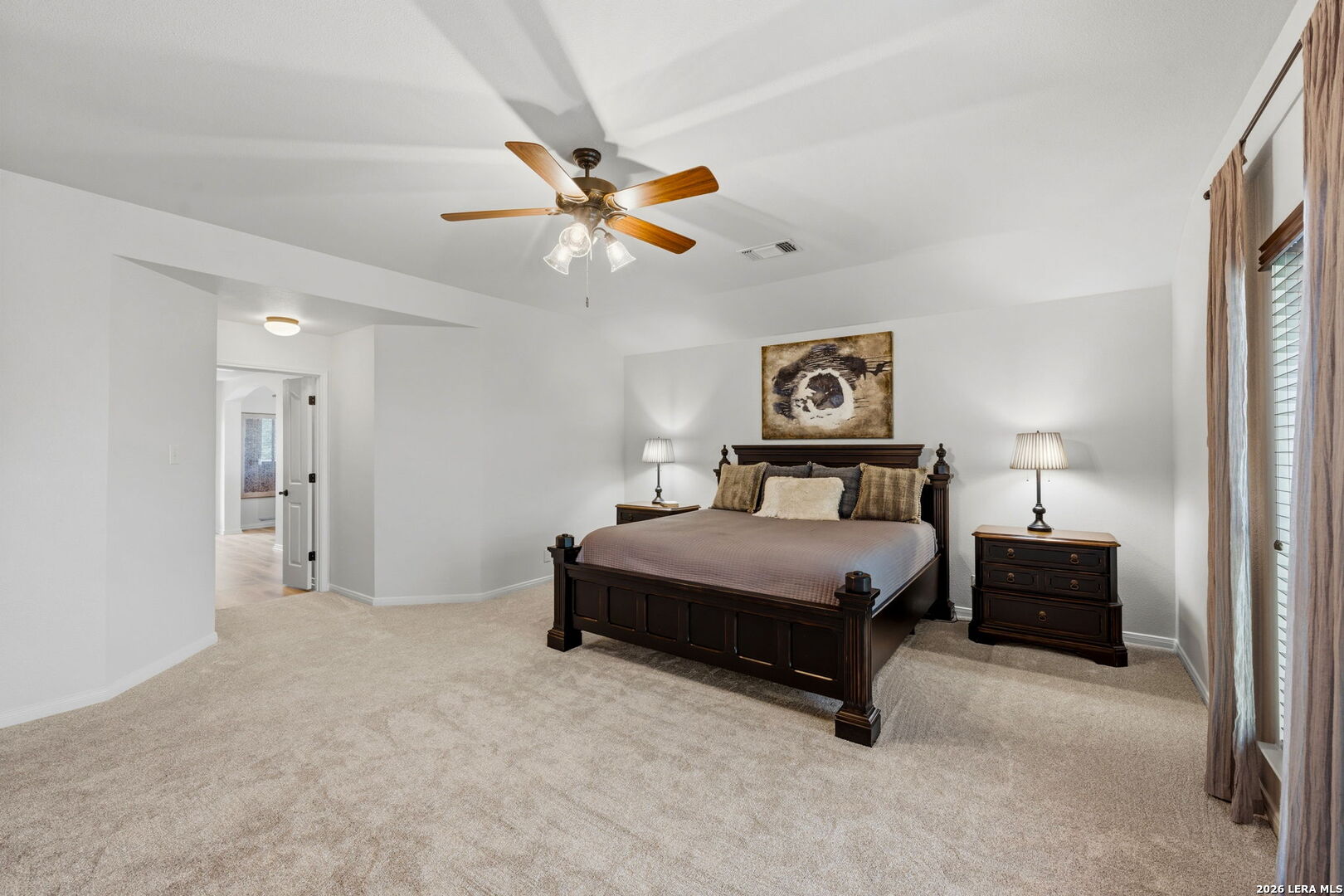 14507 John David Helotes, TX 78023 - Photo 41 of 52 a bedroom with a bed and a chandelier