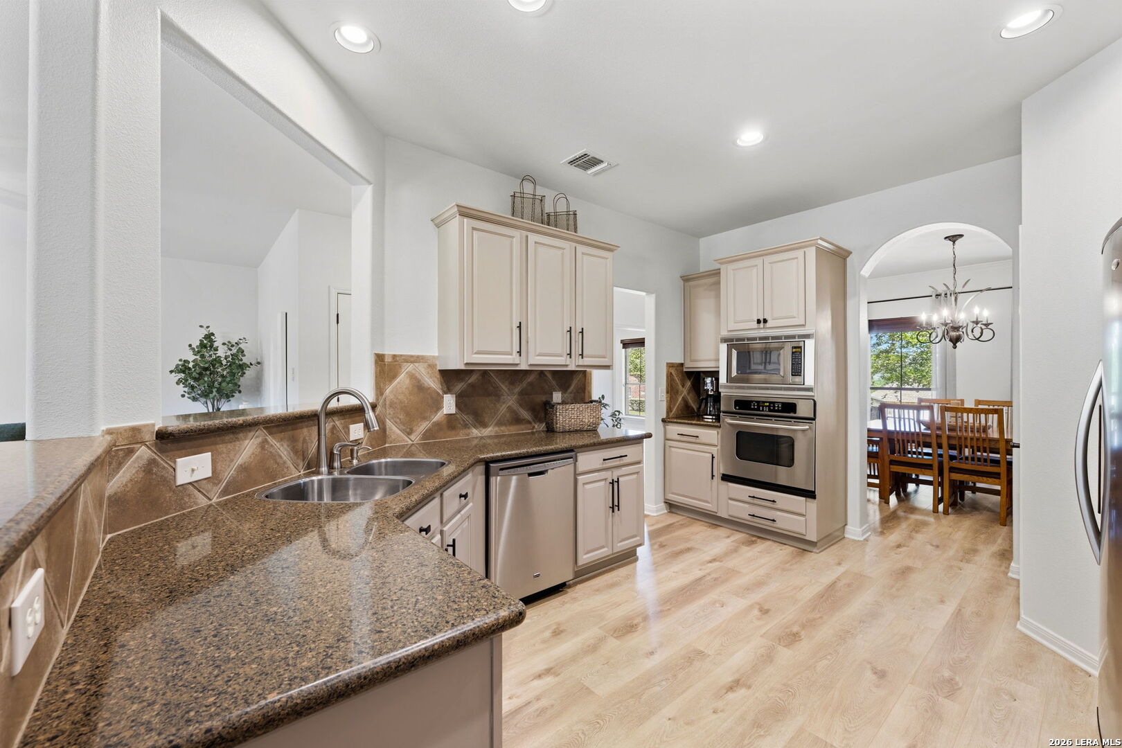 14507 John David Helotes, TX 78023 - Photo 6 of 52 a kitchen with stainless steel appliances granite countertop a sink a stove and a refrigerator
