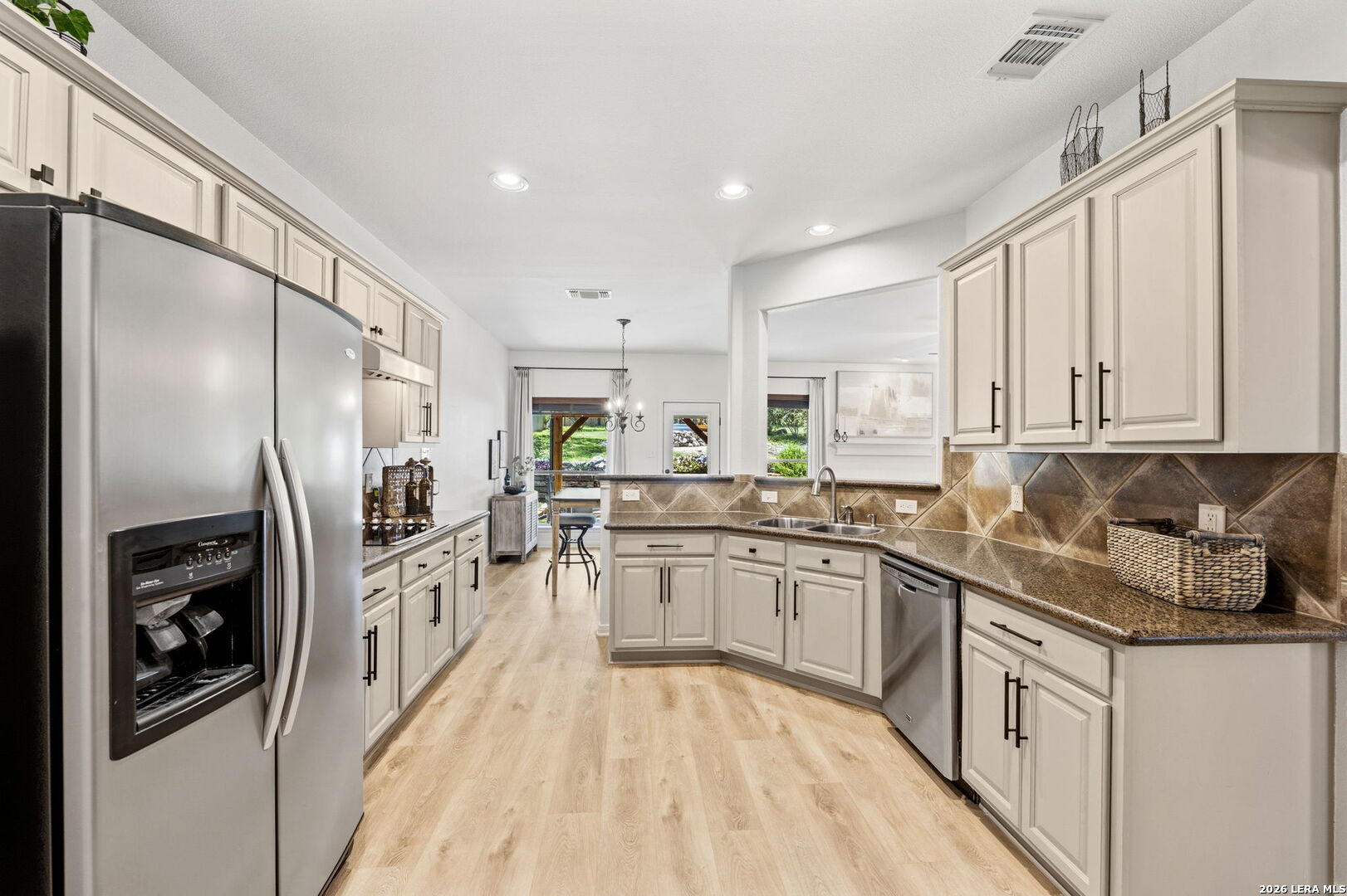 14507 John David Helotes, TX 78023 - Photo 7 of 52 a kitchen with stainless steel appliances granite countertop a refrigerator a stove and a sink