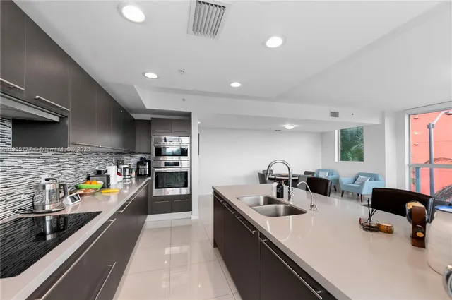 a kitchen with stainless steel appliances a sink a stove and a refrigerator