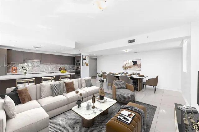 a living room with furniture and view of kitchen