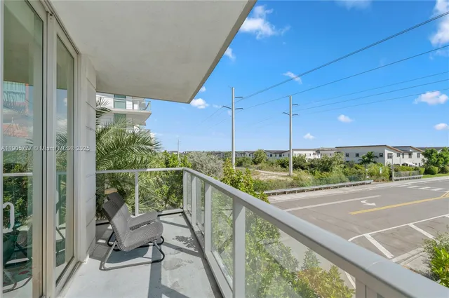 a view of a two chairs in the balcony