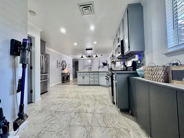 a kitchen with stainless steel appliances granite countertop a refrigerator and a stove