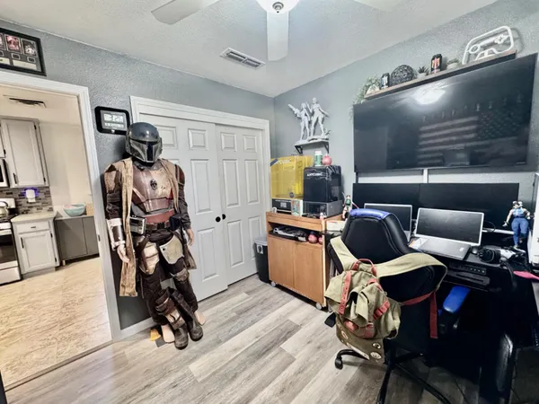 a room with furniture a flat screen tv and a window