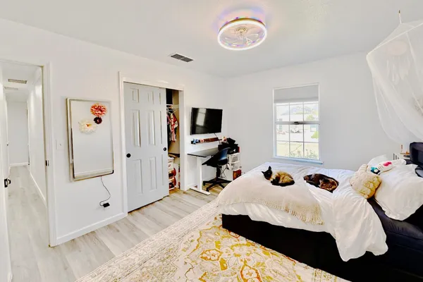 a bed room with a bed and a book shelf