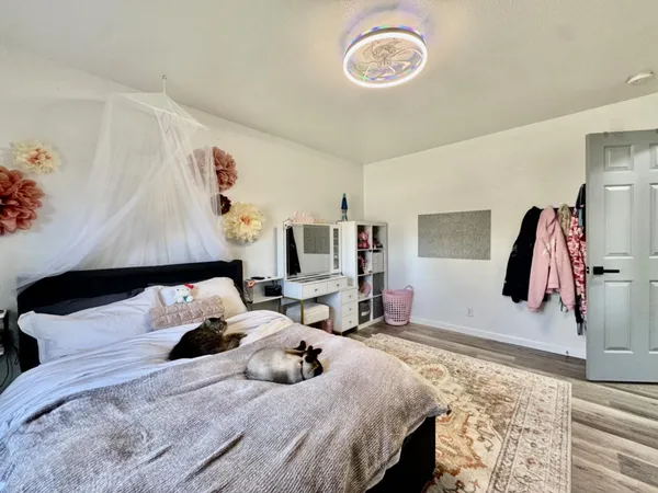 a bedroom with a bed and a flat screen tv