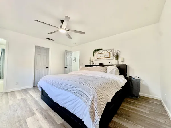 a bed room with a bed and a chandelier