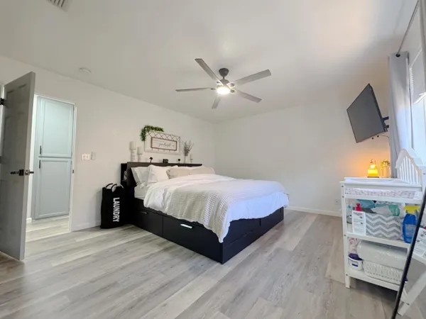 a spacious bathroom with a granite countertop sink toilet a large mirror a shower and a bathtub
