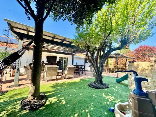 a view of a backyard with sitting area