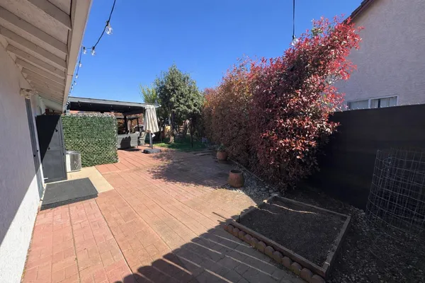 a view of a patio in a backyard