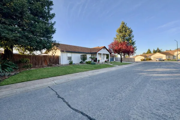 a view of house with outdoor space and parking