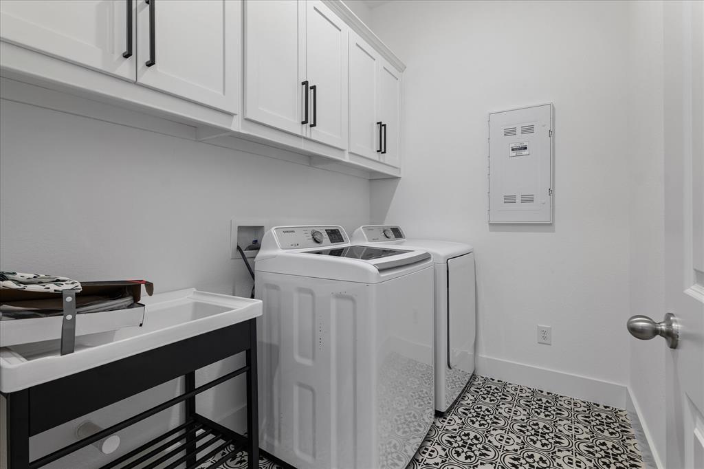 1332 Thompson Road Argyle, TX 76226 - Photo 28 of 36 Laundry area with cabinet space, washer and dryer, and light tile patterned floors