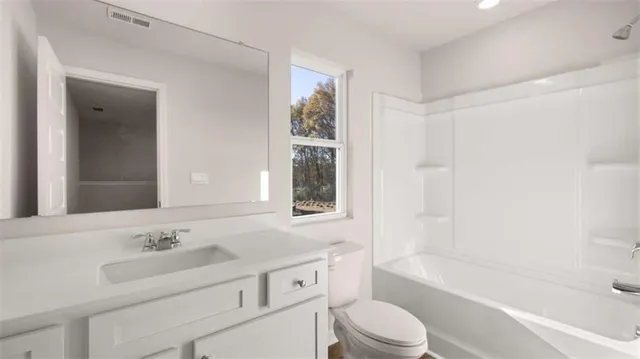 a front view of a house with a yard table and chairs